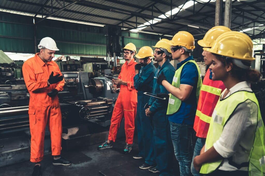 Skillful worker attending brief meeting in the factory . Industrial people and manufacturing labor concept .