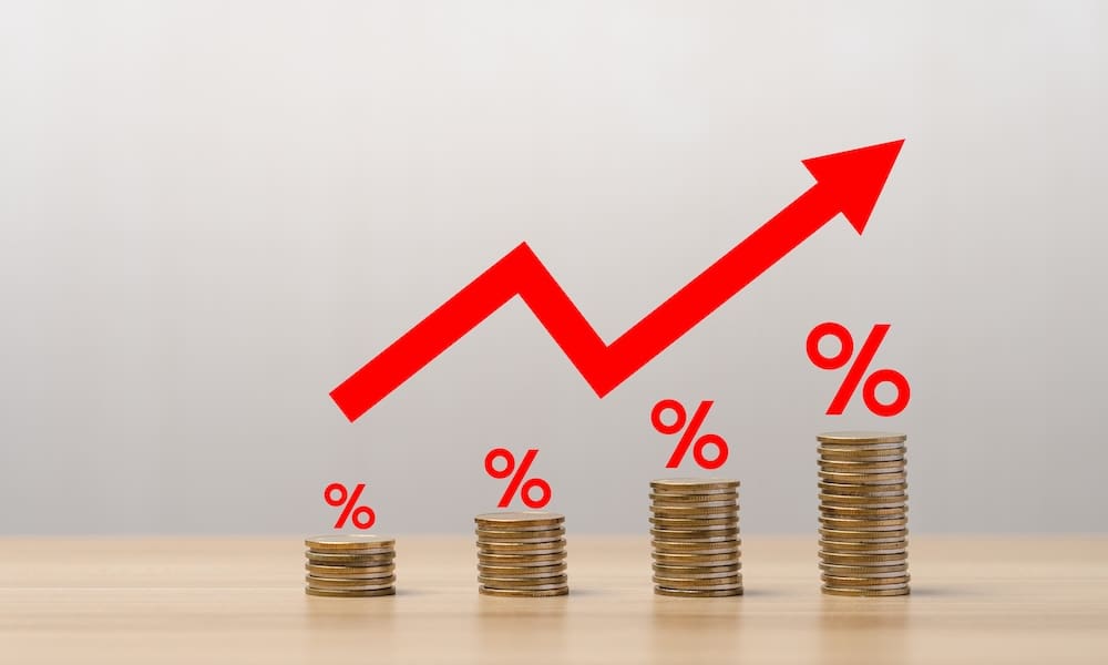 Unveiling the Dynamics of Stop-Loss Premium Increases in Healthcare - Stacks of coins with a graph arrow showing the increase