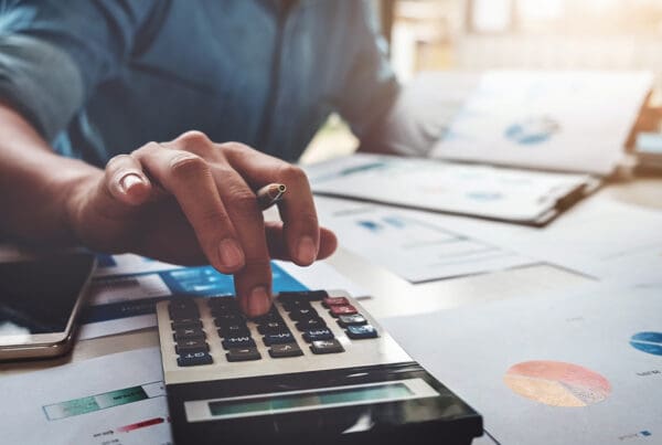 Blog - Business Accounting Concept, Business Man Using Calculator With Computer Laptop, Budget and Loan Paper in Office