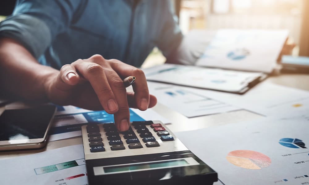 Blog - Business Accounting Concept, Business Man Using Calculator With Computer Laptop, Budget and Loan Paper in Office