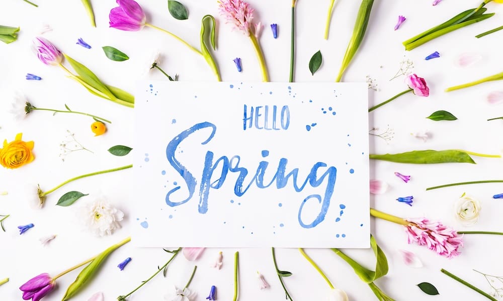 Easter and spring flat lay on a white wooden background.